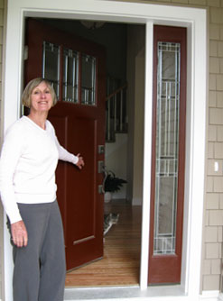 Sue Powers at the front door of her new condo.