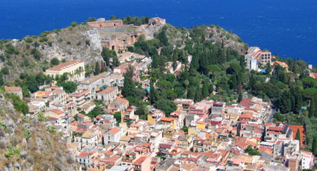 Taormina with its ruins and its houses out on the point.