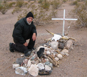 a mock gravesite in the campground with a cattle scull and old boots.