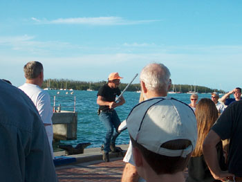 A story teller entertains a crowd on Mallory Square.