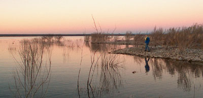 Dean walks along the lake