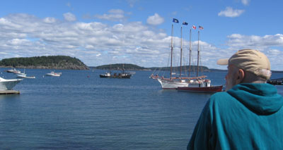 A 4-masted schooner graces the dock.
